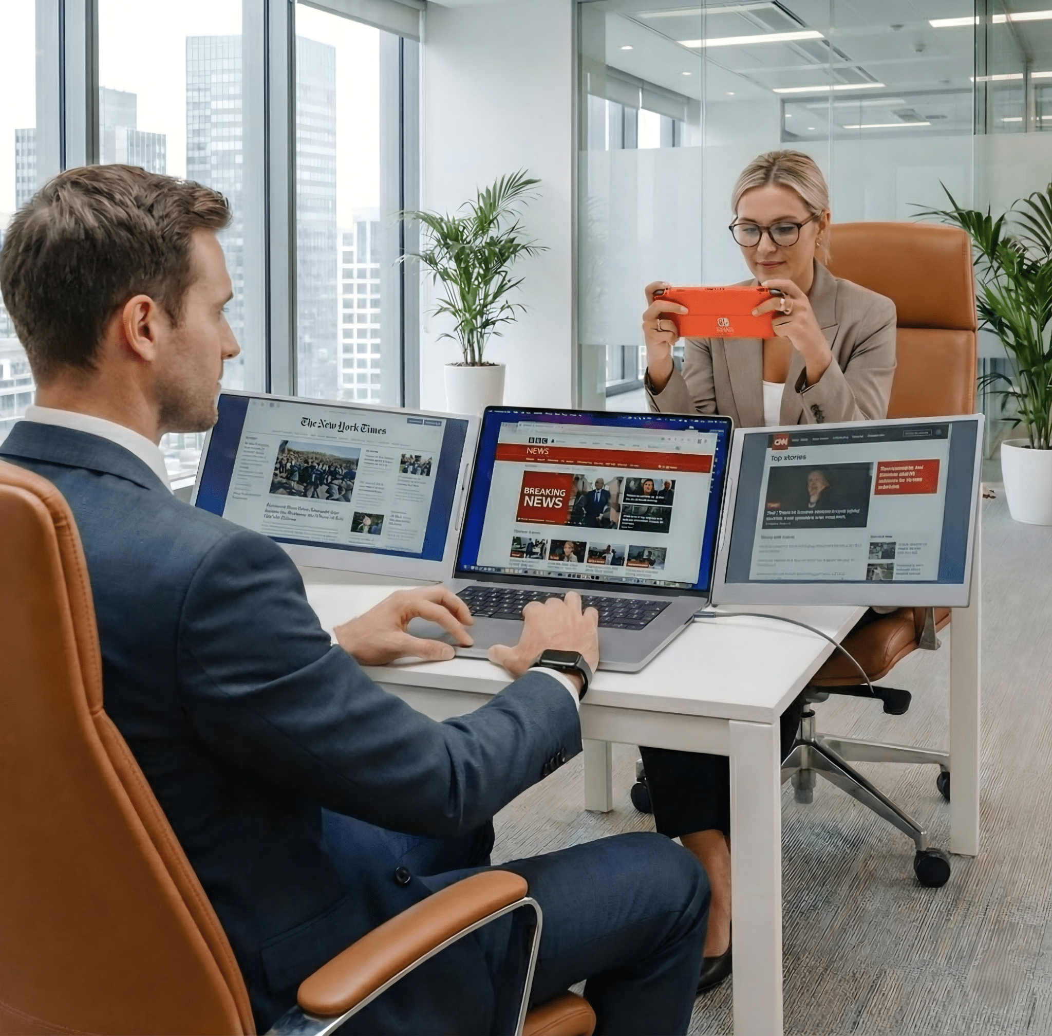 Business professional using MagHub Trio Go 16" portable triple screen extender with a laptop for multi-window news monitoring and office productivity